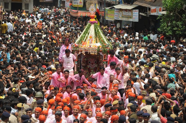 Devotees throng around a chariot bearing
